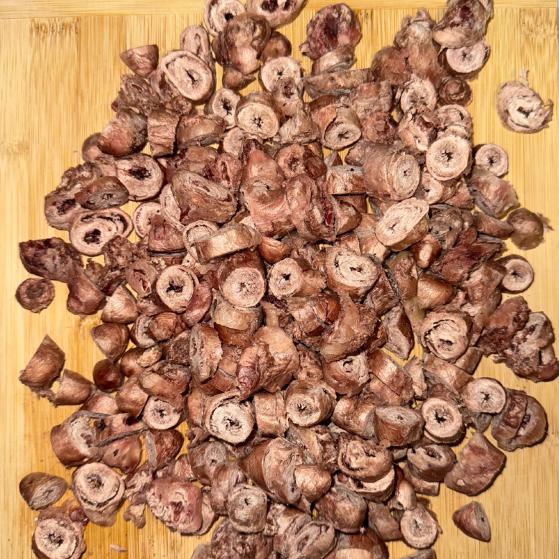 freeze-Dried chicken hearts on a wooden cutting board